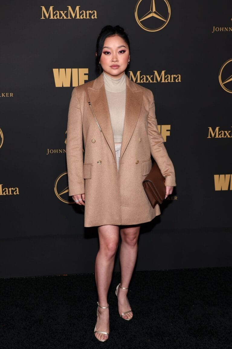 Lana Condor: Wears an elegantly cut beige coat over a top and skirt set…