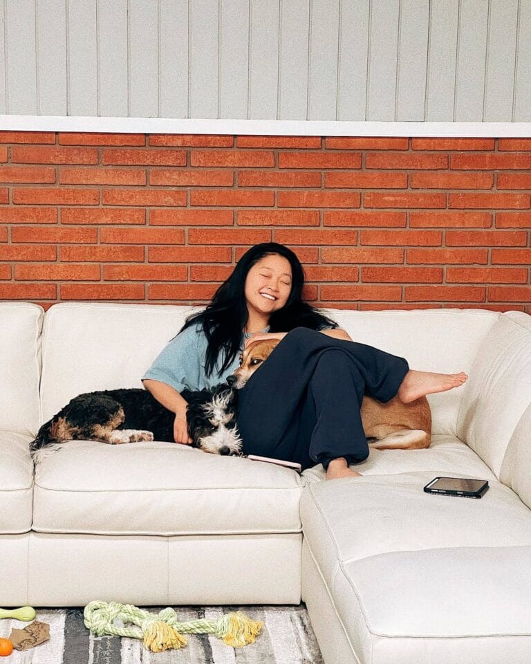 Lana Condor: Poses on a white sofa, in a light-colored T-shirt and comfortable pants,…