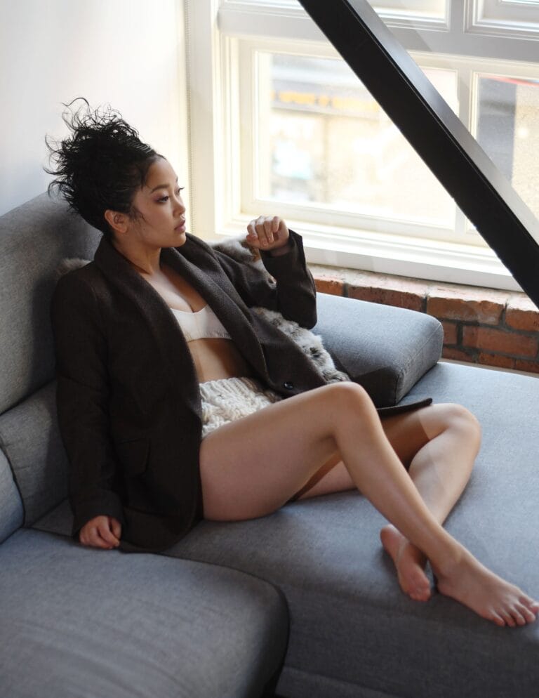 Lana Condor: Wears a loose-fitting brown coat paired with a white top and…
