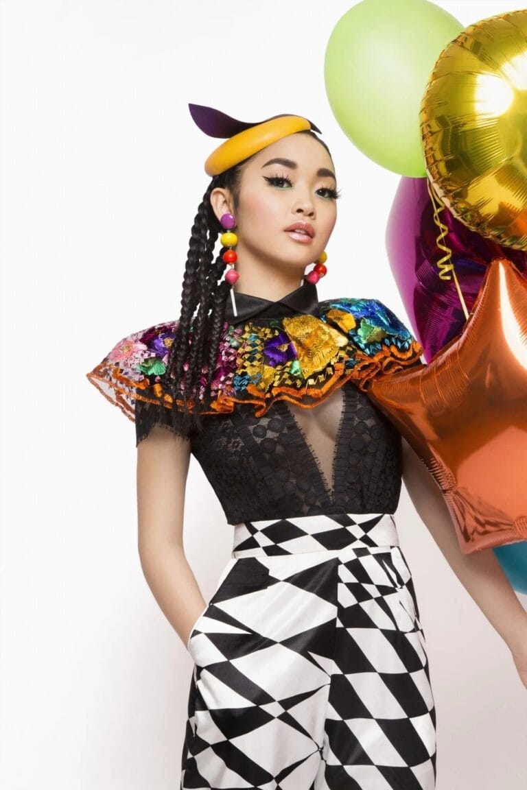 Lana Condor: Wears a black top with lace details and an eye-catching colorful collar, which…