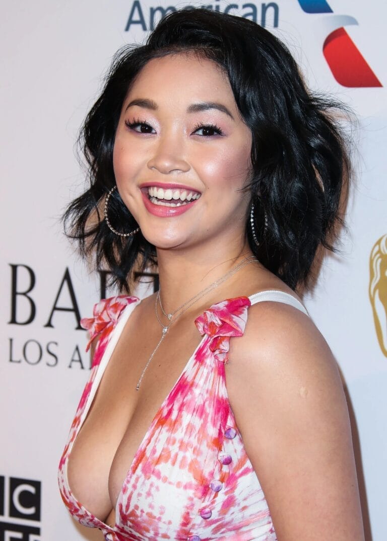 Lana Condor: Wears a pink-print dress with straps, featuring a deep neckline…