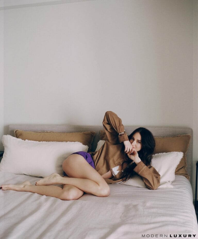 Shailene Woodley: Wears an oversized brown shirt paired with purple shorts while lying on her side…