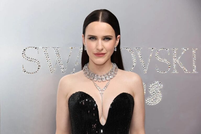 Rachel Brosnahan: She wears a black sequin dress with a deep V-neck that enhances her…