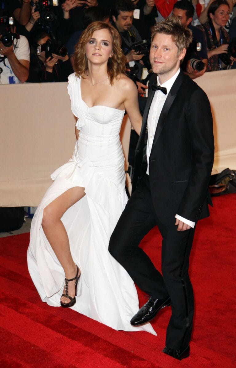Emma Watson: Wears a white one-shoulder dress with a side slit that reveals…