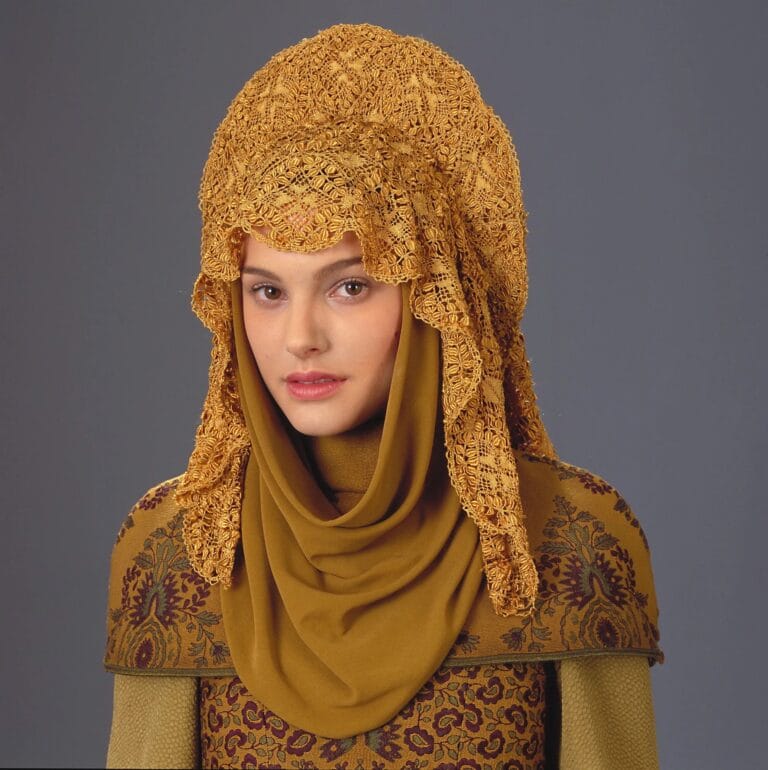 Natalie Portman: Wears an elaborate gold lace headpiece that elegantly spreads over her head,…