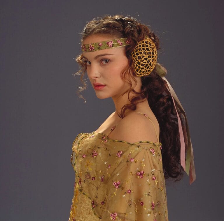 Natalie Portman: Wears a long yellow chiffon dress with delicate floral embroidery in pink tones,…