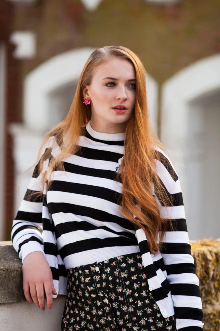 Sophie Turner: Wears a black and white striped sweater with a high-neck design…