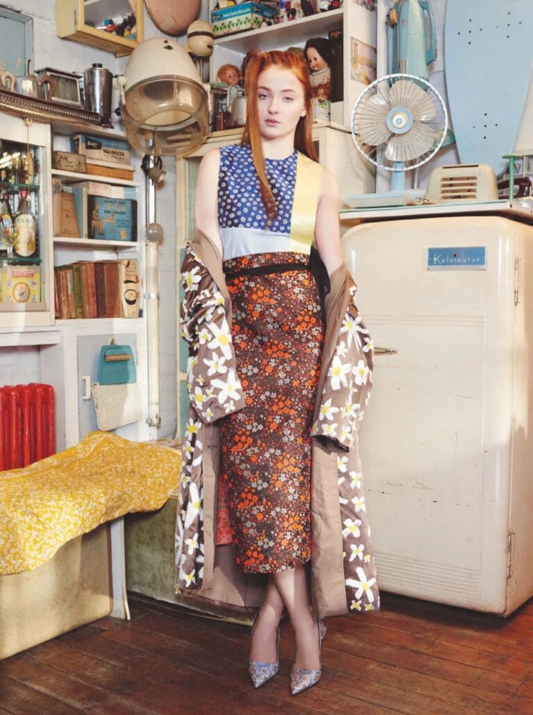 Sophie Turner: Wears a fitted dress with a floral print in brown and orange tones, paired with…