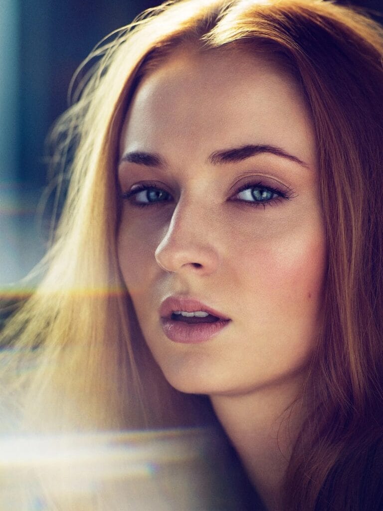 Sophie Turner: Wears a serene expression, with her hair loose and slightly tousled, framing her…