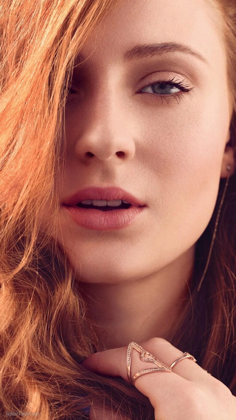 Sophie Turner: Wears delicate pink-toned jewelry while playing with her curly, loose hair.…