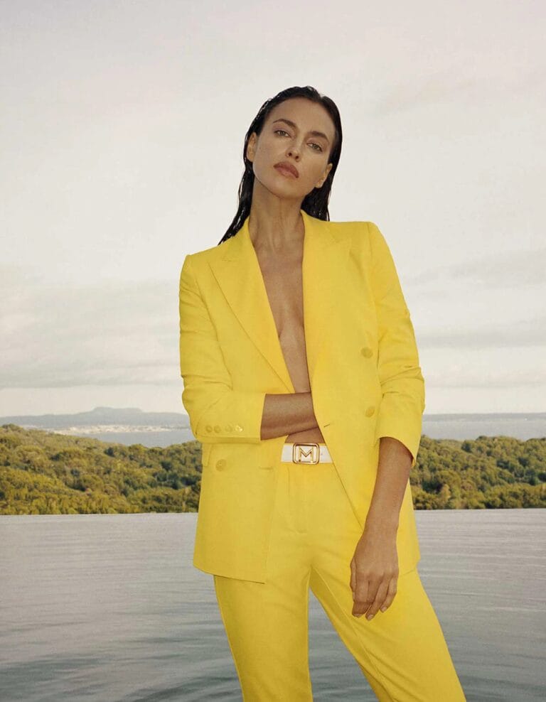 Irina Shayk: Wearing a vibrant yellow suit with a straight-cut blazer and fitted pants,…