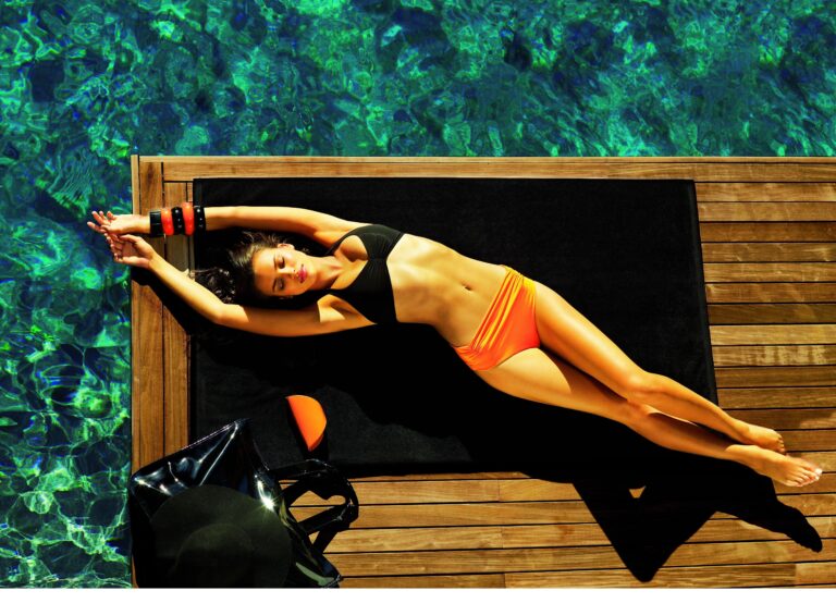 Irina Shayk: Wears a black bikini that highlights her figure, paired with a bottom of…