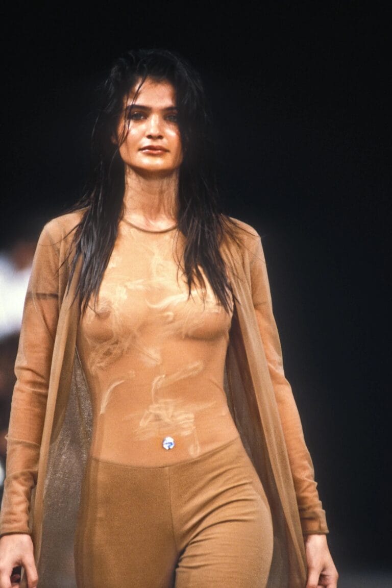 Helena Christensen: Wears a nude sheer set that hugs the body, with a…