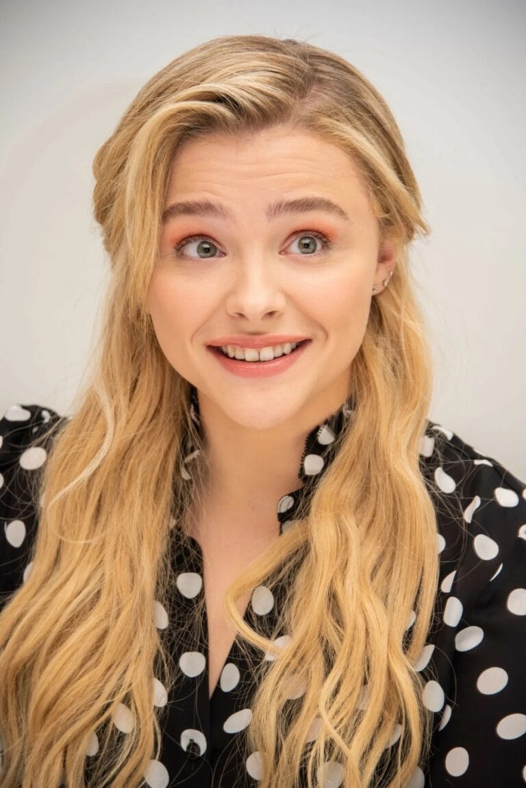 Chloë Grace Moretz: Wears a black blouse with large white polka dots, showing a fresh and casual style.…