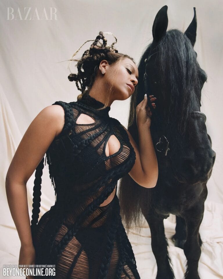 Beyoncé: Wears a black mesh dress with strategic cutouts that highlights her figure, while…