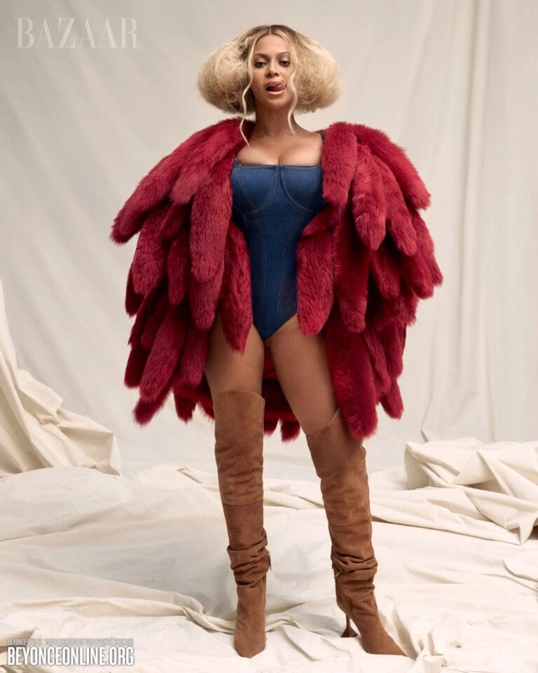 Beyoncé: Wears a denim swimsuit that highlights her figure, paired with a coat of…