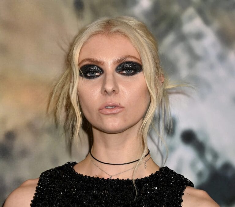 Taylor Momsen: Wearing a fitted black sequin dress that highlights her figure,…