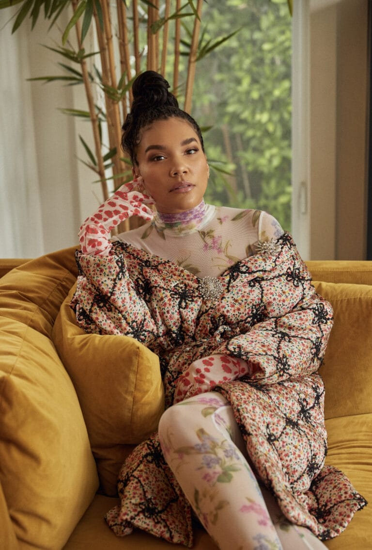 Emmy Raver-Lampman: Wears a bold look with a floral coat in soft tones and black, which…
