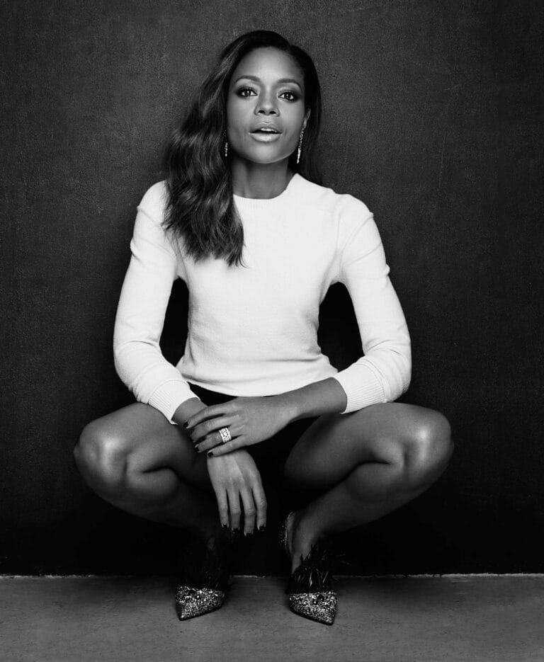 Naomie Harris: Wears a fitted white sweater and black shorts, in a crouching pose…
