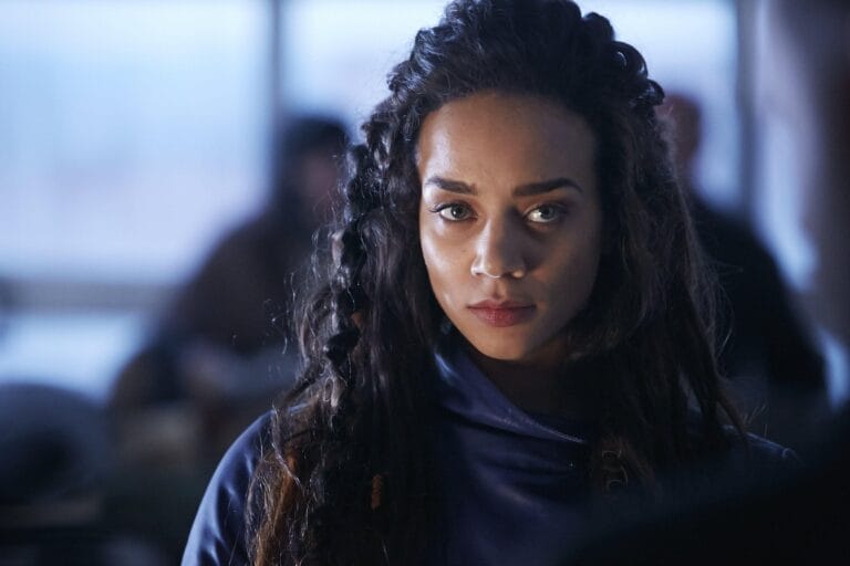 Hannah John-Kamen: Wears a dark blue outfit with a minimalist, elegant design that…