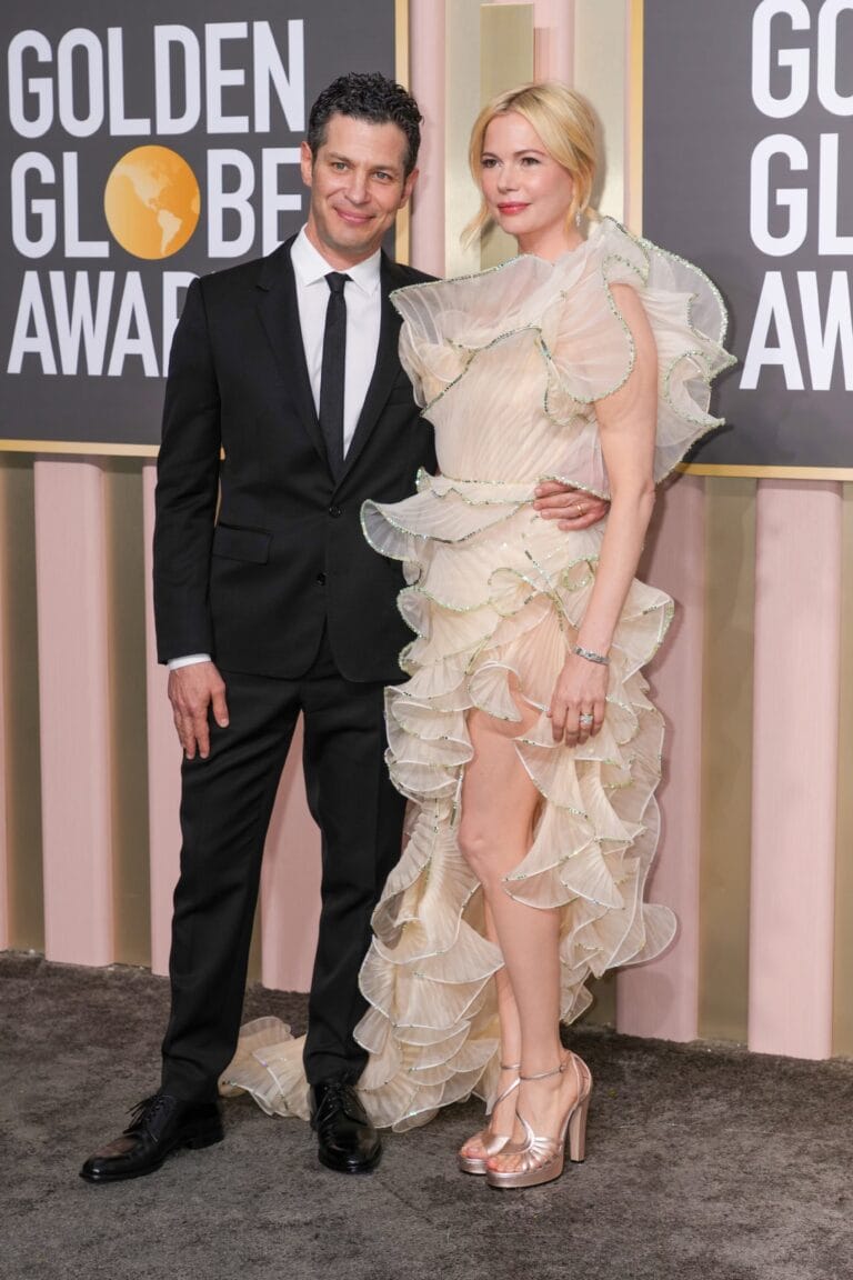 Michelle Williams: Wears a flowy nude dress trimmed with ruffles and beaded…