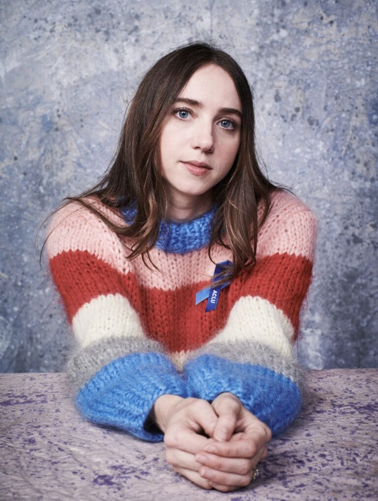 Zoe Kazan: Wears a wool sweater with wide stripes in red, pink, white and…