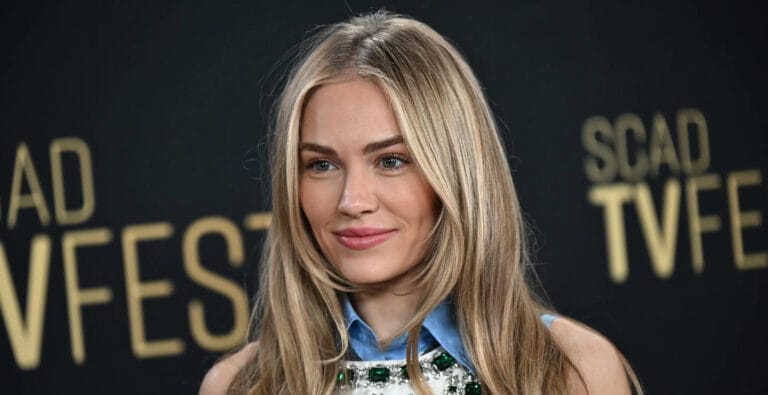 Michelle Randolph: Wearing an elegant top with sparkly details and a blue shirt underneath, standing out in…