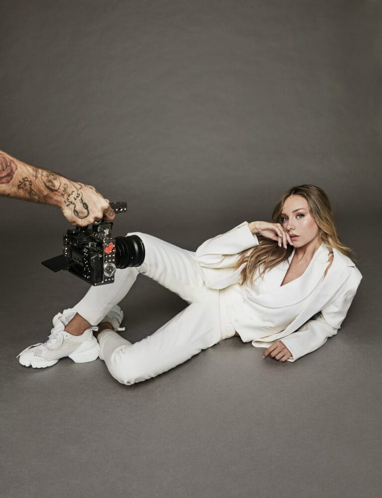 Ester Expósito: Wears an elegantly cut white suit, lying on her side with one leg…
