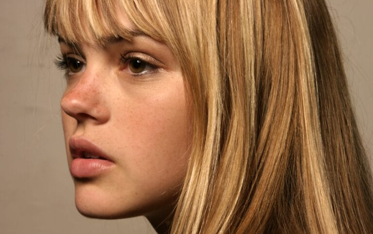 Aimee Teegarden: Shown in profile, with blonde, straight hair falling softly over her shoulders…