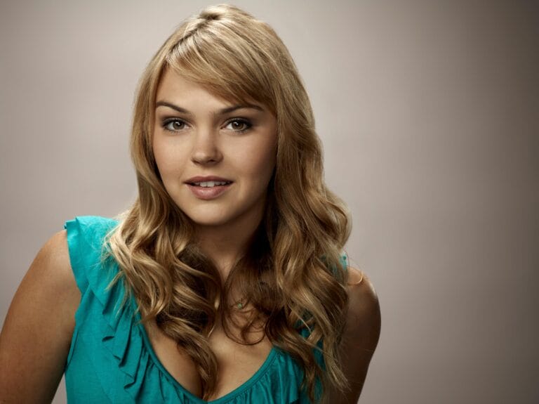 Aimee Teegarden: Wearing an aqua-green blouse with ruffle details, highlighting her figure…