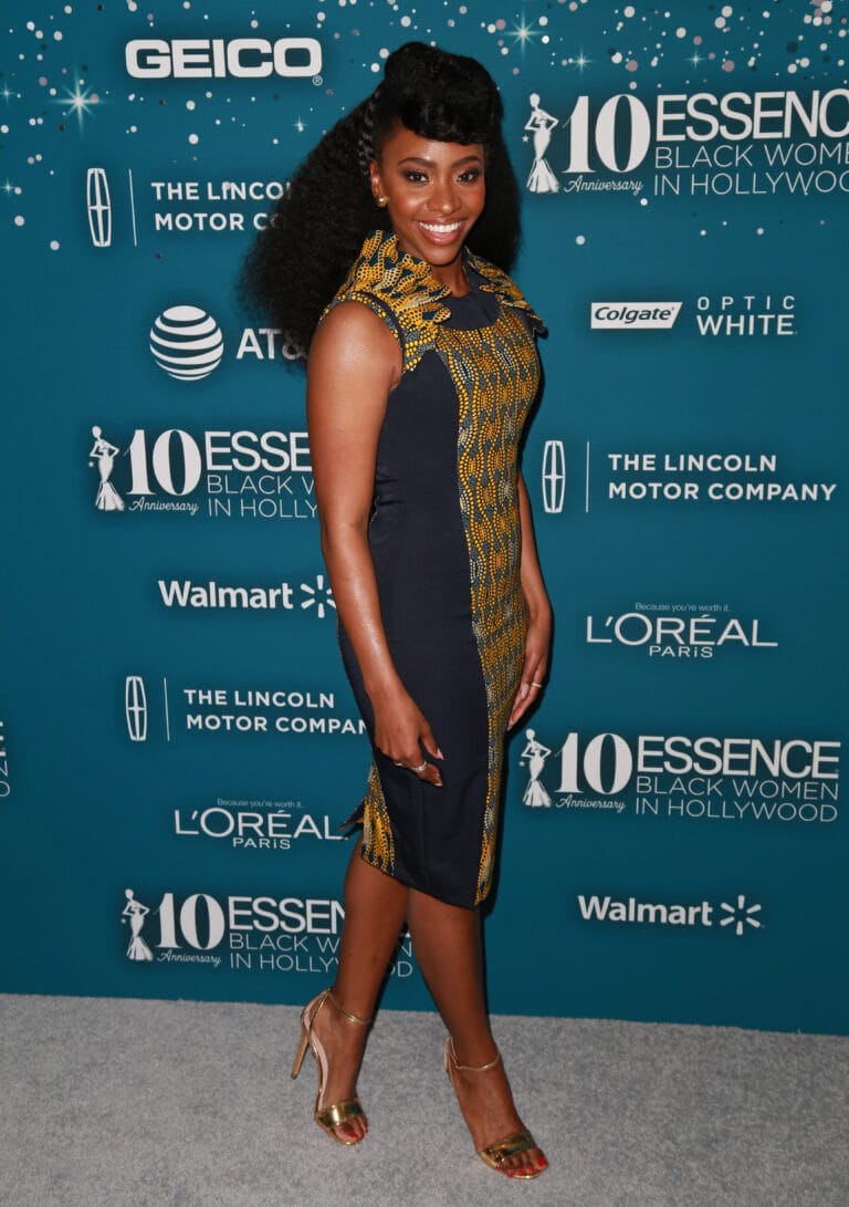 Teyonah Parris: Wears a fitted black dress with yellow details and a design…