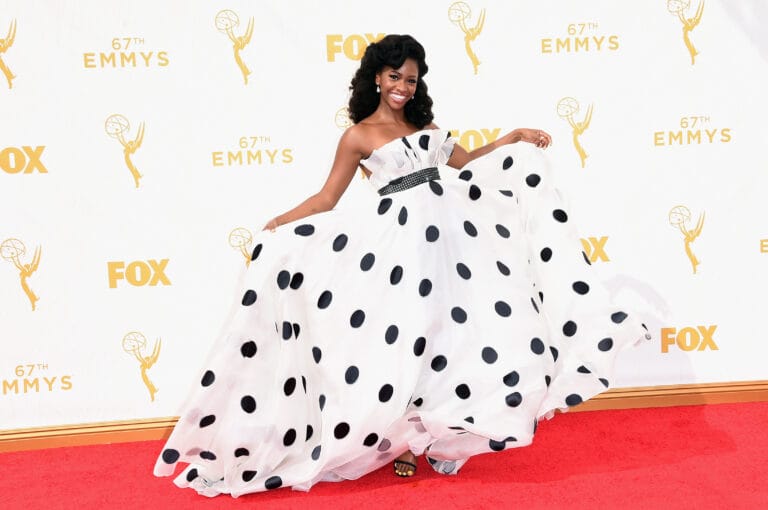 Teyonah Parris: Wears a voluminous white strapless dress with large black polka dots, creating…