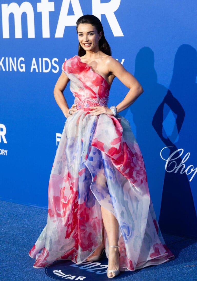 Amy Jackson: Wears an asymmetrical gala dress with a floral print in pink and blue tones,…