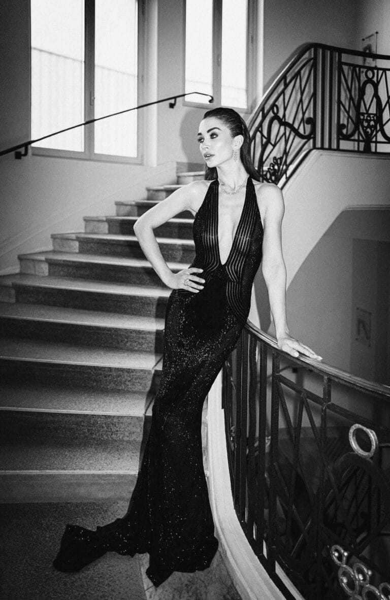 Amy Jackson: Wears a fitted black dress with a deep neckline and shimmering details that highlights…