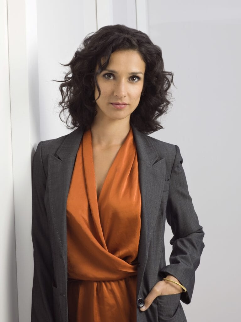 Indira Varma: Wears an elegant ensemble with a gray blazer over an orange silk blouse,…