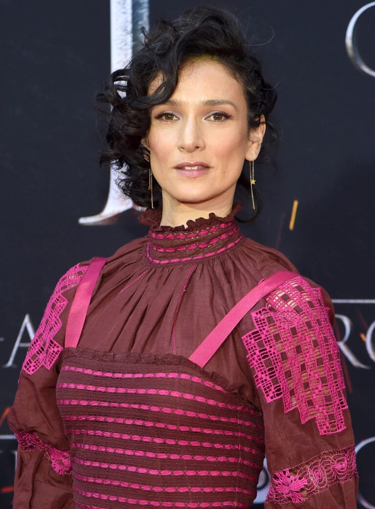 Indira Varma: Wears a brown dress with vibrant pink details, standing out for its design…