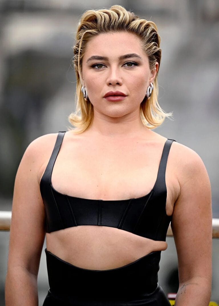 Florence Pugh: Wears a black leather outfit with bold cuts that accentuate the figure, highlighting…