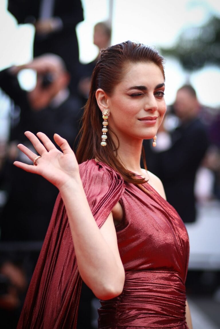 Miriam Leone: Wearing a metallic red one-shoulder dress that highlights her figure with…