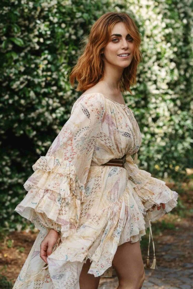 Miriam Leone: Wearing a flowy dress with a soft floral print, bell sleeves and…