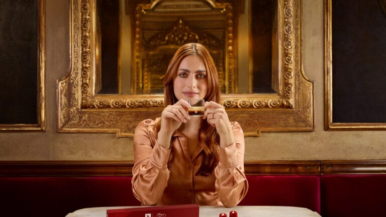 Miriam Leone: Holding a crystal glass with a drink, wearing a satin blouse in…