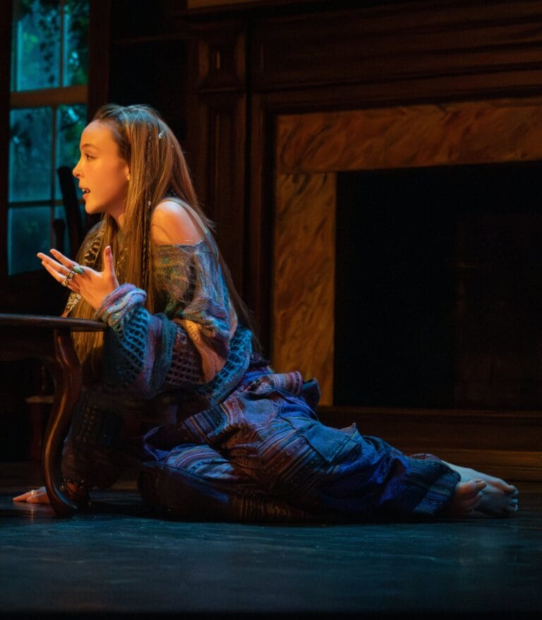 Ella Beatty: Wears a bohemian outfit, with a soft-colored sweater that leaves one shoulder…