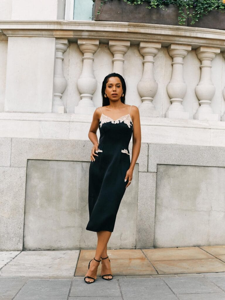 Kerry Washington: Wears a black satin dress with lace details on the top,…