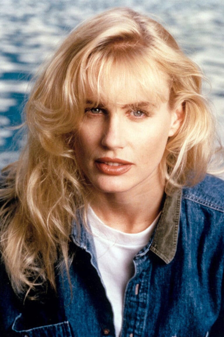 Daryl Hannah: Wears a denim shirt over a white T-shirt, with blonde hair and…