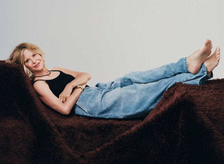 Meg Ryan: Wears a black sleeveless T-shirt and wide-leg jeans, lying on…