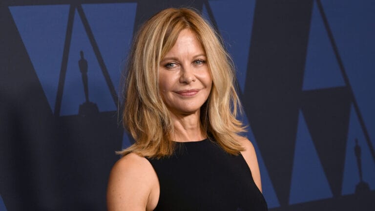 Meg Ryan: Wears an elegant, fitted black sleeveless dress that shows off her figure. Posing…