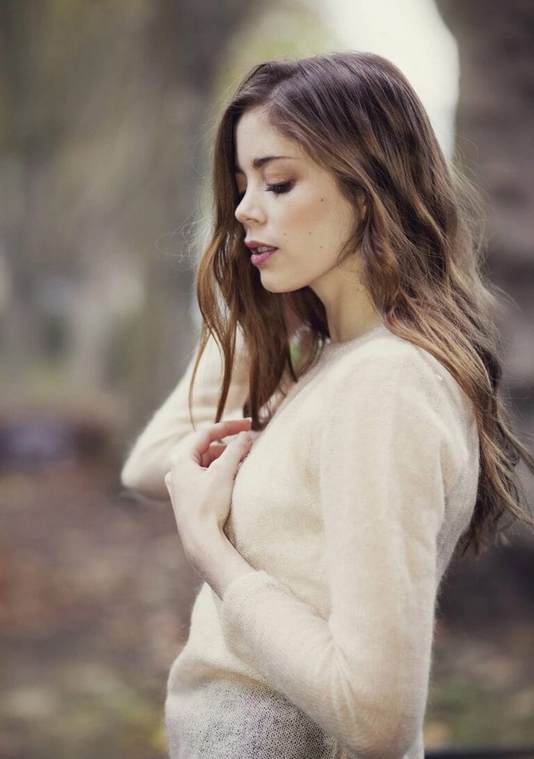 Charlotte Hope: Wears a soft cream-colored sweater with a simple cut that highlights her…