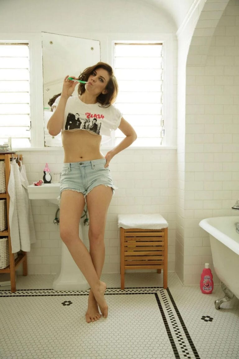 Lauren Cohan: Luce una camiseta corta blanca con un estampado gráfico, combinada con shorts de denim…