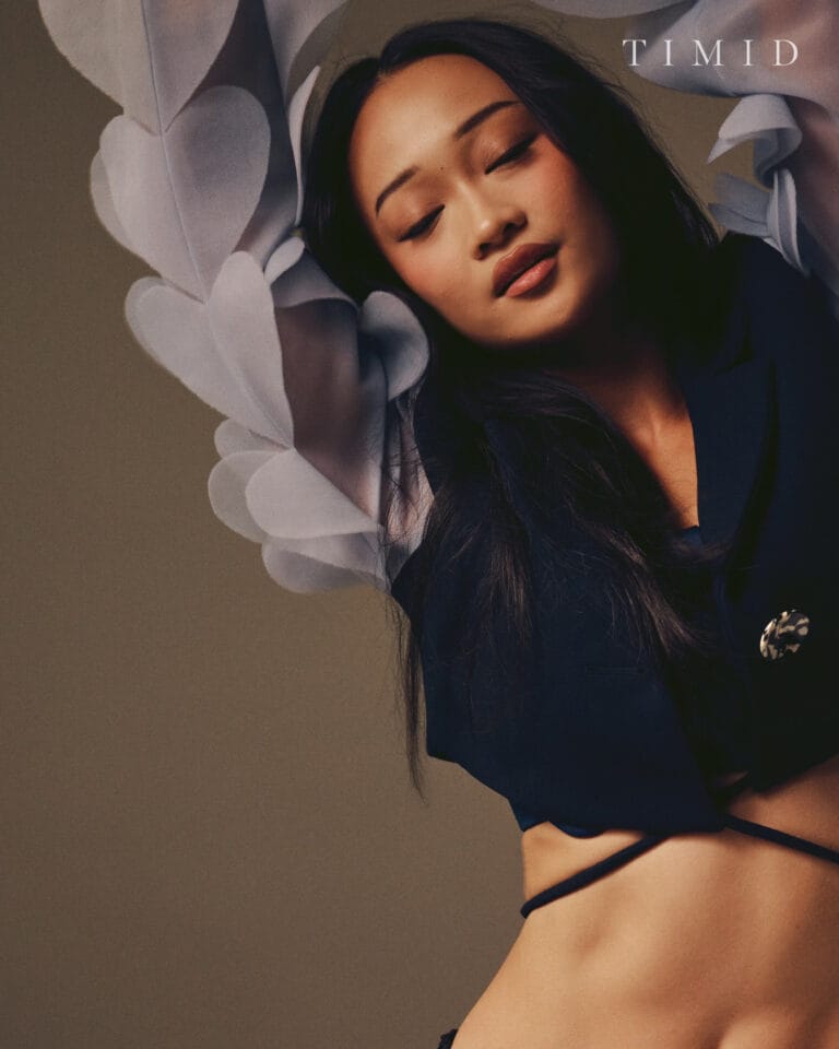 Callina Liang: Wears a sophisticated outfit with a black top that highlights the figure, complemented by…