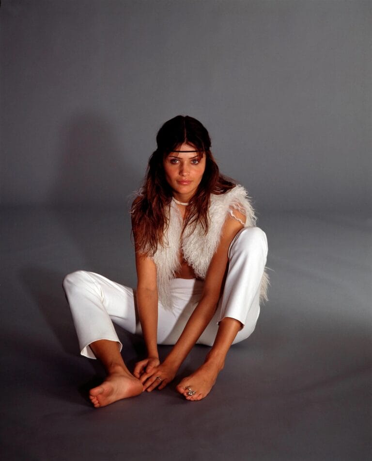 Helena Christensen: Wears an all-white outfit, with a sleeveless top in a soft textured fabric…