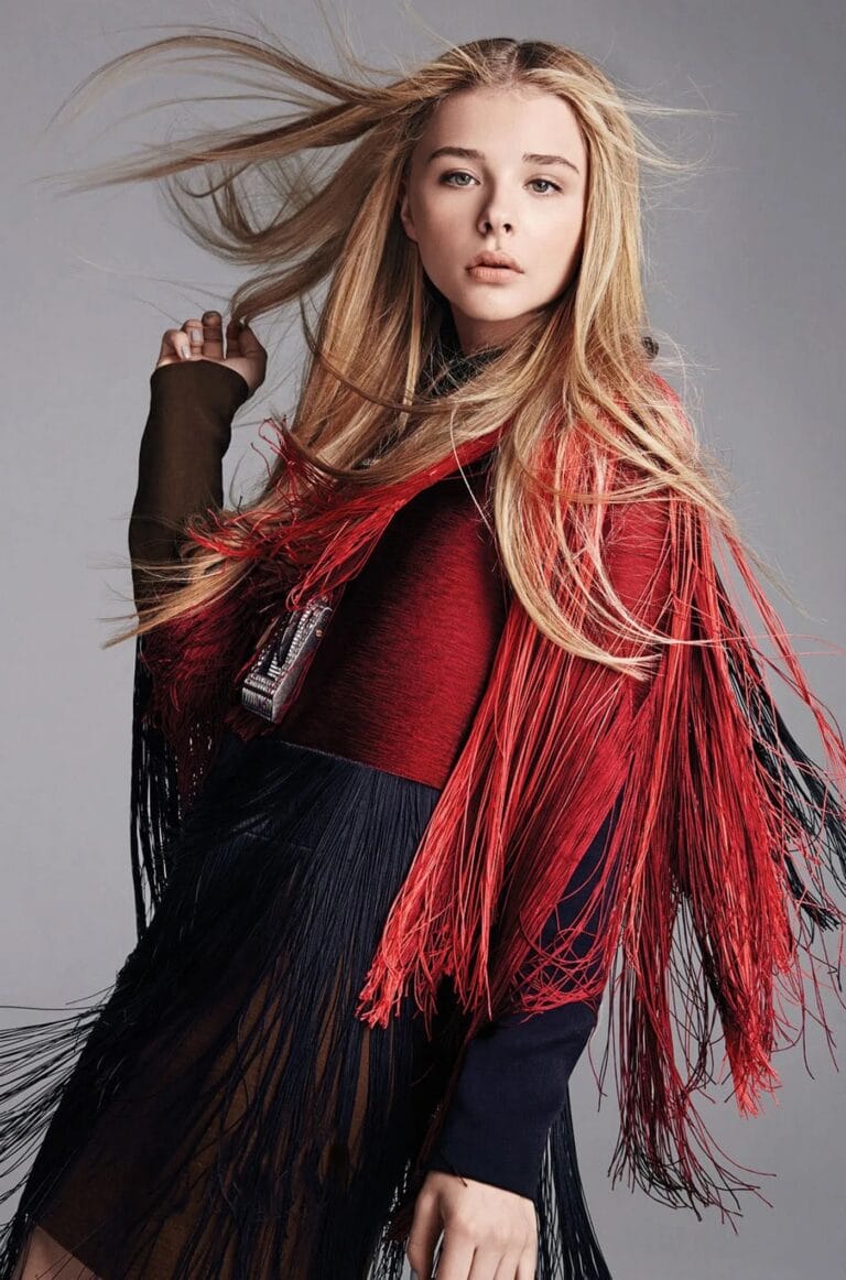 Chloë Grace Moretz: Wears a jacket with red and black fringe that adds a bold and…